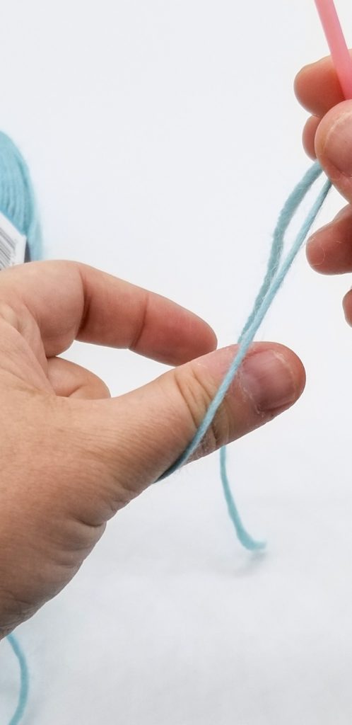 Knitting needle with a cast on stitch